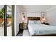 Calming bedroom with sliding glass doors, a cozy bed, and artwork at 1010 68Th Nw St, Bradenton, FL 34209
