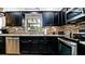 Well-appointed kitchen with stainless steel appliances, dark cabinets, and stylish backsplash at 1010 68Th Nw St, Bradenton, FL 34209