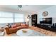 Cozy living room featuring a leather sofa, hardwood floors, and plenty of natural light at 1010 68Th Nw St, Bradenton, FL 34209