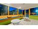 Enclosed patio offers stylish seating with tiled floors and beautiful backyard views through large windows at 1010 68Th Nw St, Bradenton, FL 34209