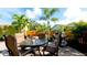 Outdoor patio features a table with seating, barbecue grill, and lush tropical landscaping at 1010 68Th Nw St, Bradenton, FL 34209