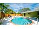 Heated pool with attached hot tub surrounded by lush tropical foliage and white sand at 1010 68Th Nw St, Bradenton, FL 34209