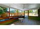 Inviting sunroom boasts built-in seating, a ceiling fan, and views of the outdoor pool area at 1010 68Th Nw St, Bradenton, FL 34209