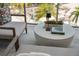 Modern balcony featuring stylish outdoor seating, a textured rug, and a sleek round coffee table with decorative accents at 111 S Pineapple Ave # 813, Sarasota, FL 34236