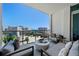 Spacious balcony with comfortable lounge seating, offering stunning city and ocean views, perfect for relaxing and entertaining at 111 S Pineapple Ave # 813, Sarasota, FL 34236