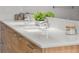 Bathroom with a double sink vanity, white countertop, wood cabinets and silver hardware at 111 S Pineapple Ave # 813, Sarasota, FL 34236