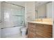 Bathroom with a shower/tub combo, floating shelves, toilet, wood vanity and a large mirror at 111 S Pineapple Ave # 813, Sarasota, FL 34236
