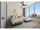 Bedroom with two twin beds, large windows with city view, ceiling fan, and gallery wall at 111 S Pineapple Ave # 813, Sarasota, FL 34236