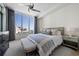 Well-lit bedroom with large window view, ceiling fan, and tastefully coordinated furniture and decor at 111 S Pineapple Ave # 813, Sarasota, FL 34236