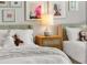 Bedroom with two twin beds, gallery wall with a lamp on the nightstand between beds at 111 S Pineapple Ave # 813, Sarasota, FL 34236