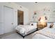Bedroom featuring two beds, gallery wall with pictures, and doorway to bathroom at 111 S Pineapple Ave # 813, Sarasota, FL 34236