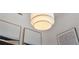 Close-up of a modern dining room chandelier with contemporary artwork and trim at 111 S Pineapple Ave # 813, Sarasota, FL 34236