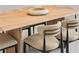Close-up of dining table and chairs showcasing the table's wood grain and unique chair design at 111 S Pineapple Ave # 813, Sarasota, FL 34236