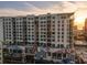 Exterior of high-rise building with balconies, palm trees, and beautiful sunset at 111 S Pineapple Ave # 813, Sarasota, FL 34236