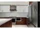 Modern kitchen features white cabinets, stainless steel appliances, and wooden accents at 111 S Pineapple Ave # 813, Sarasota, FL 34236