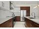 Elegant kitchen with sleek appliances, dark wood accents and white cabinets and countertops at 111 S Pineapple Ave # 813, Sarasota, FL 34236