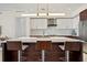 Kitchen island with seating and pendant lighting, with stainless steel appliances and modern cabinetry at 111 S Pineapple Ave # 813, Sarasota, FL 34236