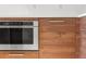 Close-up of a stainless steel oven built into wooden cabinetry in a modern kitchen at 111 S Pineapple Ave # 813, Sarasota, FL 34236