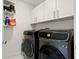 Laundry room featuring modern Samsung washer and dryer, and ample storage cabinets at 111 S Pineapple Ave # 813, Sarasota, FL 34236