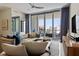 Bright living room with modern furnishings, a comfortable sofa, and an open balcony offering city views, perfect for relaxing at 111 S Pineapple Ave # 813, Sarasota, FL 34236