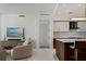 Open concept living room with modern kitchen, television, and marble floors at 111 S Pineapple Ave # 813, Sarasota, FL 34236