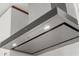 Modern range hood with sleek design and built-in lights over a white subway tile backsplash at 111 S Pineapple Ave # 813, Sarasota, FL 34236