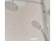 Close-up of modern chrome shower head fixtures against a marble tiled wall at 111 S Pineapple Ave # 813, Sarasota, FL 34236