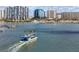 Stunning waterfront view featuring a lively harbor and stylish high-rise residential buildings under a clear blue sky at 111 S Pineapple Ave # 813, Sarasota, FL 34236