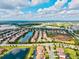 Gorgeous aerial shot of a community featuring homes with pools and lakeside views, under a blue sky at 13112 Swiftwater Way, Bradenton, FL 34211