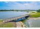 Aerial view of a lake with a walking path and bridge, perfect for enjoying nature at 13112 Swiftwater Way, Bradenton, FL 34211