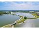 A picturesque lake with walking paths and a charming bridge, ideal for outdoor enjoyment at 13112 Swiftwater Way, Bradenton, FL 34211