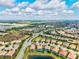 Beautiful aerial view showing homes with pools in a lakeside community under a bright sky at 13112 Swiftwater Way, Bradenton, FL 34211