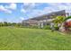Expansive backyard with a screened-in lanai, lush lawn, and privacy fencing; perfect for outdoor living at 13112 Swiftwater Way, Bradenton, FL 34211