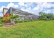Lush backyard featuring a spacious screened-in patio with a basketball hoop, and well-maintained landscaping at 13112 Swiftwater Way, Bradenton, FL 34211