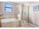 Luxurious bathroom showcasing a soaking tub, separate shower stall, and tiled surround at 13112 Swiftwater Way, Bradenton, FL 34211