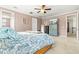 Relaxing bedroom with a ceiling fan, ample natural light, and tasteful decor in soft neutral tones at 13112 Swiftwater Way, Bradenton, FL 34211