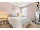 Comfortable bedroom with a ceiling fan, plush bed, and a window allowing for natural light at 13112 Swiftwater Way, Bradenton, FL 34211