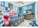 Vibrant bedroom featuring a sports theme, a large window, and a cozy bed for a comfortable retreat at 13112 Swiftwater Way, Bradenton, FL 34211