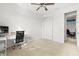 Bright, carpeted room with ceiling fan, closet, and desk setup; perfect for a bedroom or home office at 13112 Swiftwater Way, Bradenton, FL 34211