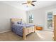 Cozy bedroom with a comfortable bed, neutral tones, a ceiling fan, and large window for natural light at 13112 Swiftwater Way, Bradenton, FL 34211