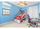 Bedroom with ceiling fan, window, and a playful basketball setup makes a fun and lively space at 13112 Swiftwater Way, Bradenton, FL 34211