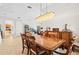 Elegant dining room with a hanging light fixture and hardwood dining set at 13112 Swiftwater Way, Bradenton, FL 34211