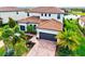 Beautiful two-story home with a tile roof, three-car garage, and lush landscaping at 13112 Swiftwater Way, Bradenton, FL 34211