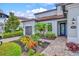Charming home entrance with a brick pathway and vibrant landscaping at 13112 Swiftwater Way, Bradenton, FL 34211