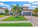 Charming two-story home featuring a three-car garage, well-manicured lawn, and lush tropical landscaping at 13112 Swiftwater Way, Bradenton, FL 34211