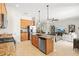 Open-concept kitchen with an island, stainless steel appliances, and seamless transition to the living area at 13112 Swiftwater Way, Bradenton, FL 34211