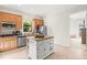 Well-lit kitchen boasts wood cabinets, stainless steel appliances, and a charming island with seating at 13112 Swiftwater Way, Bradenton, FL 34211