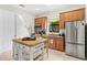 Bright kitchen showcasing stainless steel appliances, wood cabinets, granite countertops, and central island at 13112 Swiftwater Way, Bradenton, FL 34211