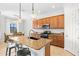 Kitchen island with granite countertop, pendant lights, and stainless steel appliances at 13112 Swiftwater Way, Bradenton, FL 34211