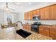 Kitchen features granite counters, modern appliances, and a breakfast bar with pendant lighting at 13112 Swiftwater Way, Bradenton, FL 34211